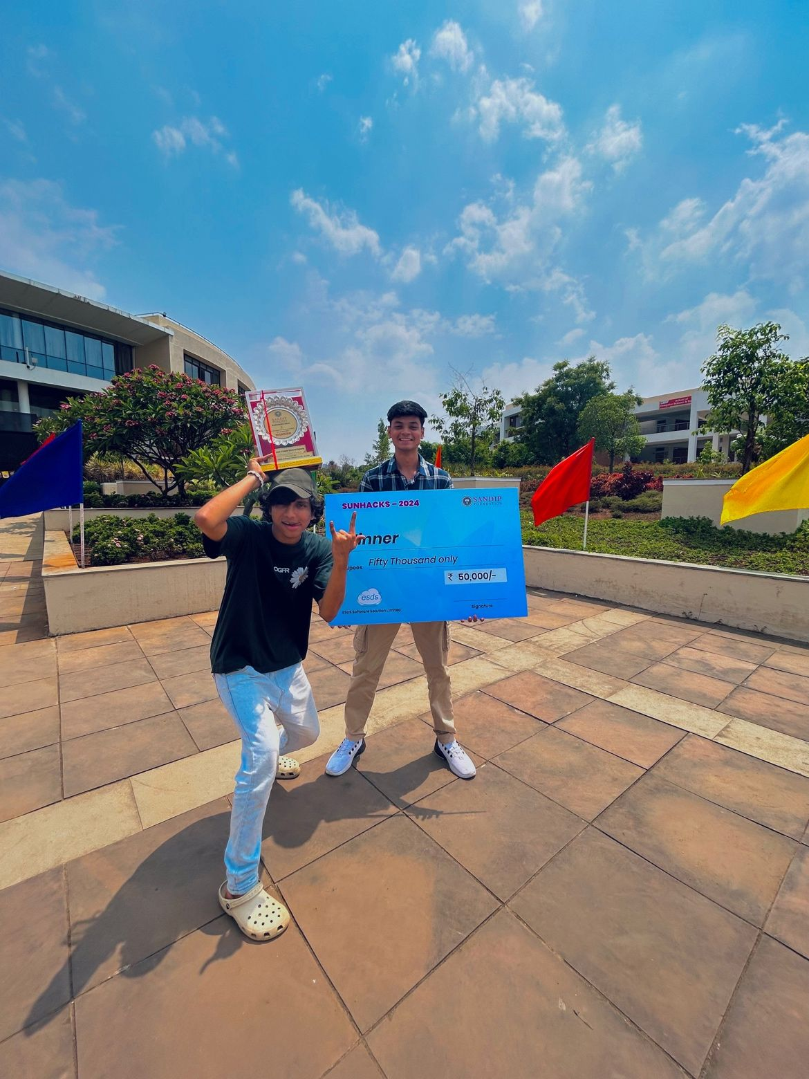 Holding the Sunhacks winner cheque and trophy